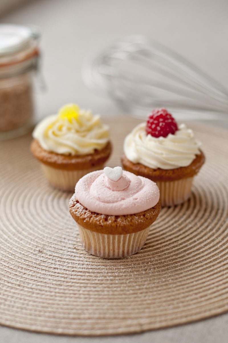 Close up of 3 beautifully decorated Italian cupcakes, showcasing a variety of flavours with toppings and frosting made by Biscotti di Debora of Cambridge.