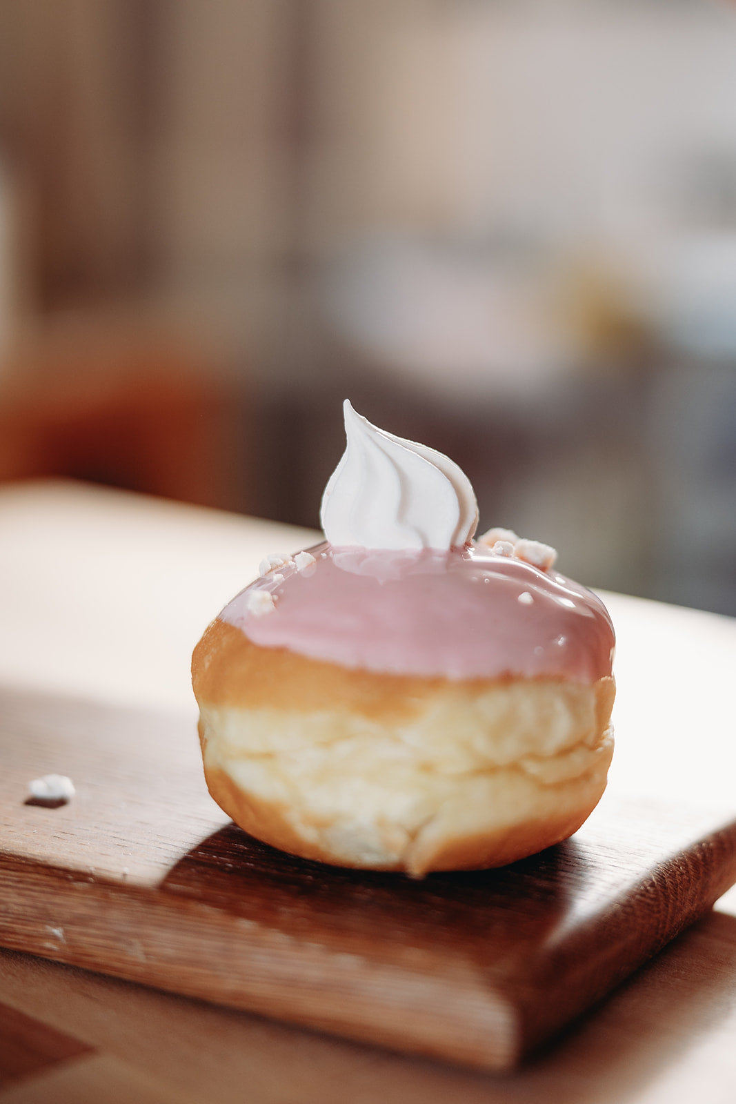 Close up of a glazed filled doughnut that is freshly baked by Biscotti di Debora.
