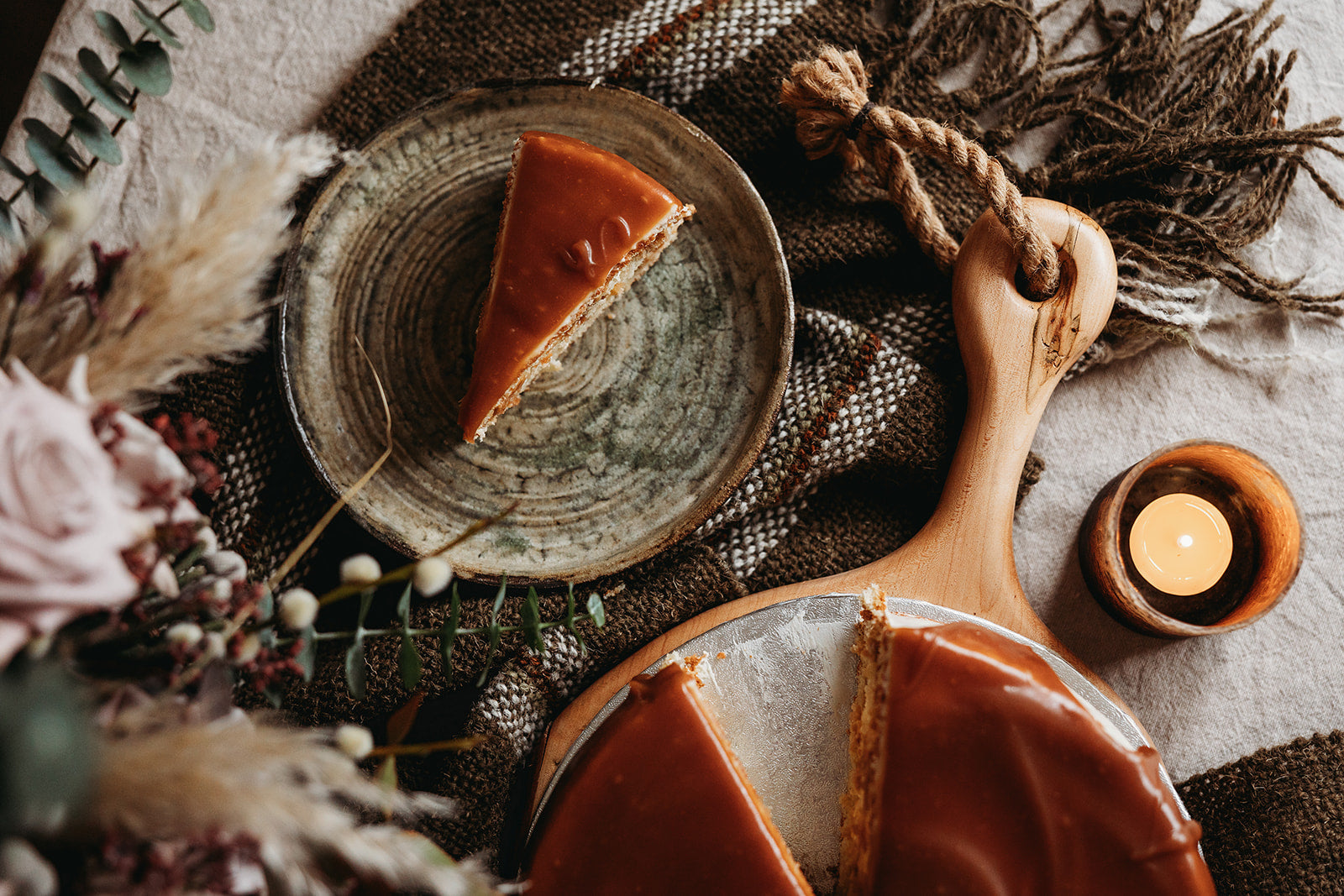 A slice of salted caramel cake on a small plate, handmade in Cambridge by Biscotti di Debora.