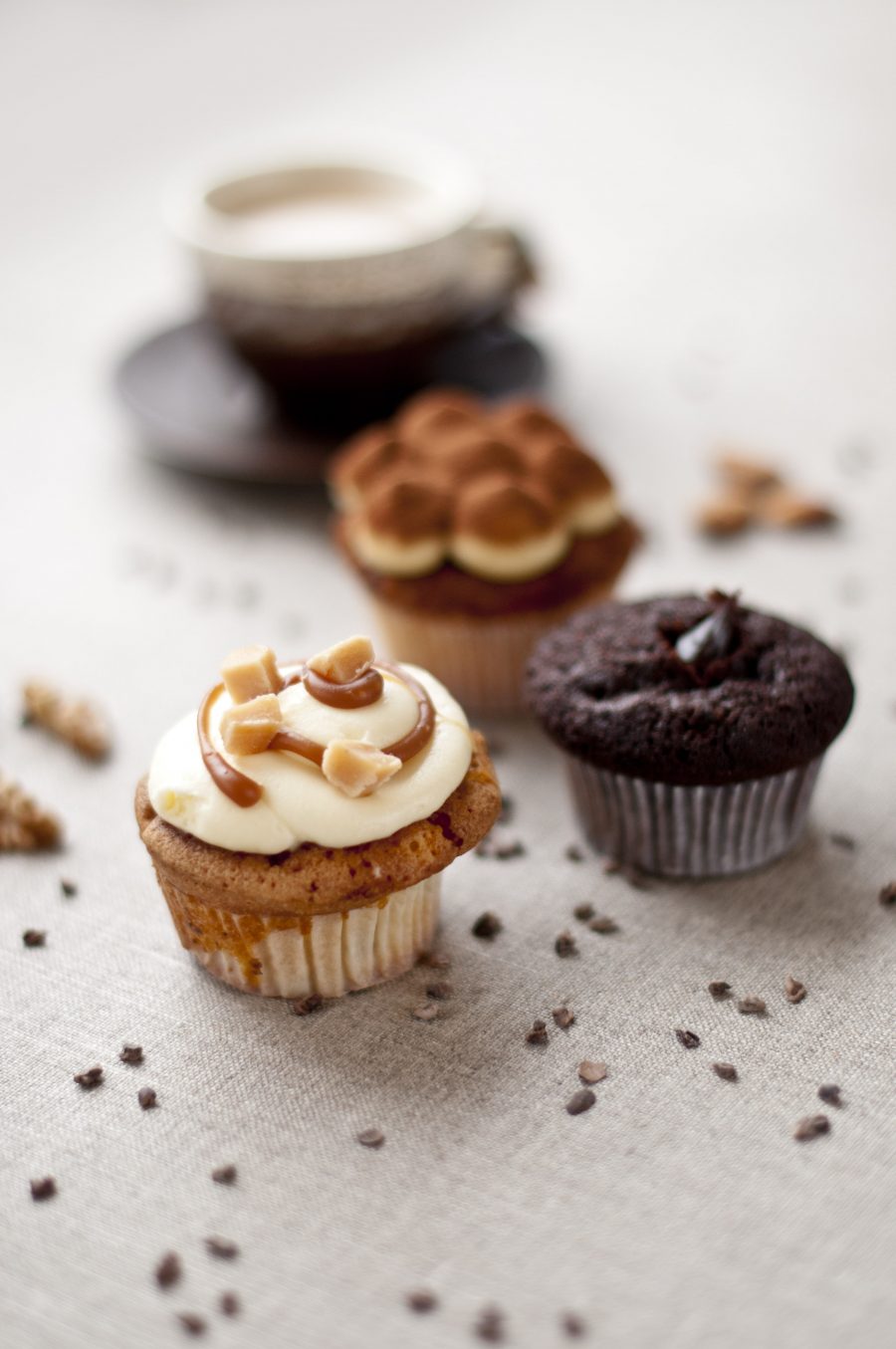 Close up of a selection of beautifully decorated cupcakes, showcasing a variety of flavours with toppings and frosting made by Biscotti di Debora of Cambridge.