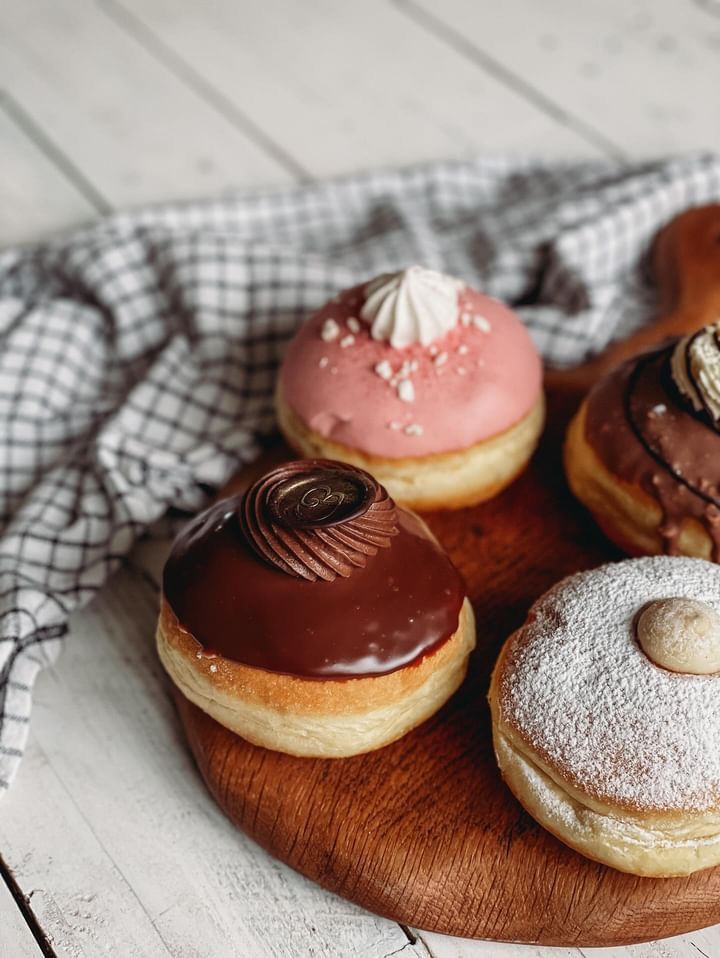 A selection of delicious freshly made doughnuts with different toppings and fillings made by Biscotti di Debora.