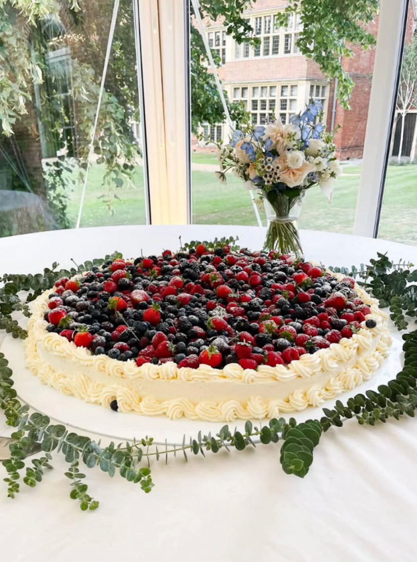 Huge fresh cake topped with fresh berries