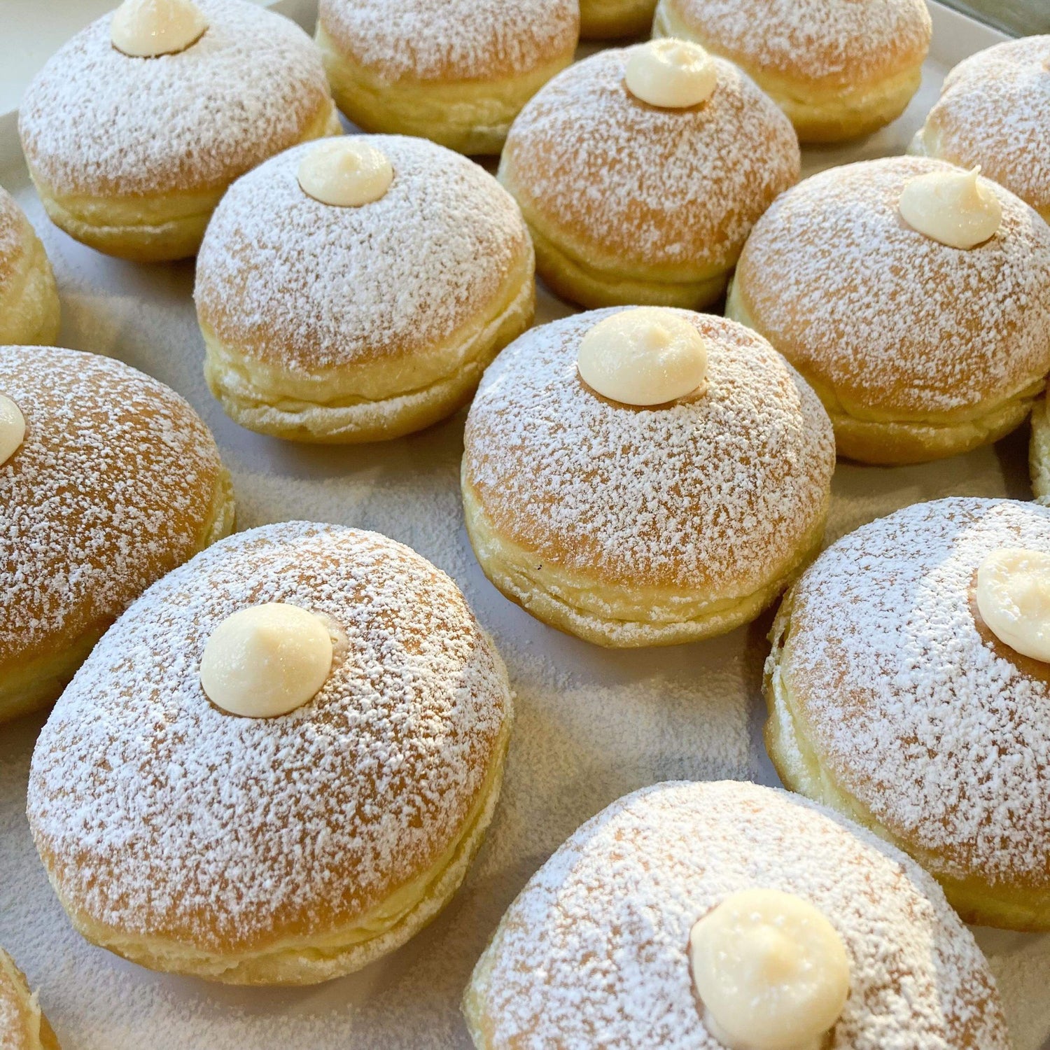 A selection of luxury freshly made doughnuts with different toppings and fillings made by Biscotti di Debora.